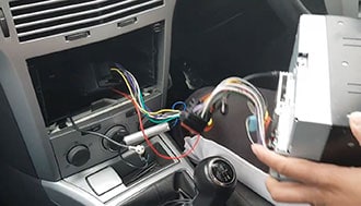 ALt: Professionelle Autolektronik-Installation im Auto-Innenraum.